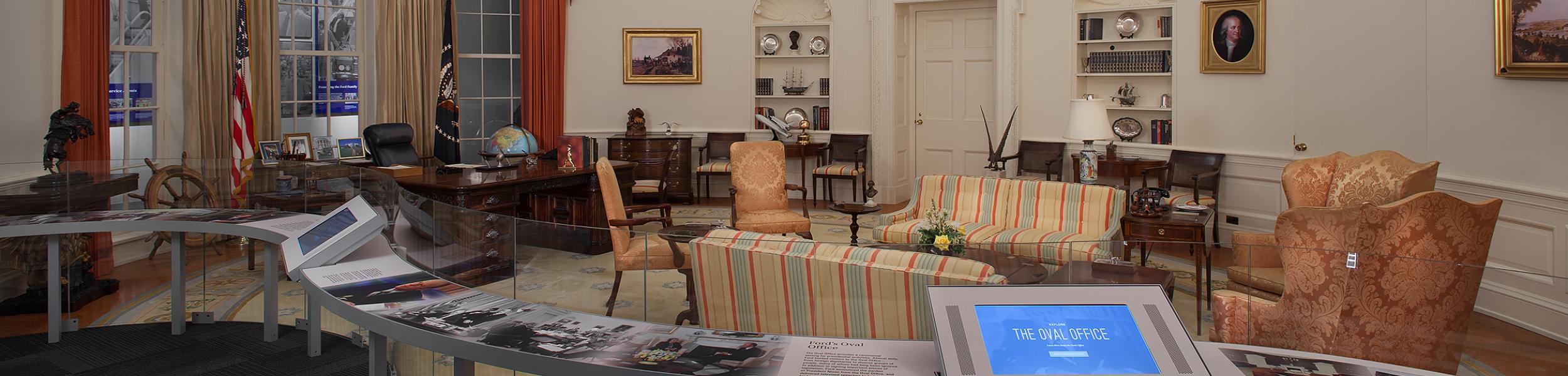 A look into the Oval Office exhibit at the museum showcasing the desk, chairs, sofas and tables arranged as they were in the White House.
