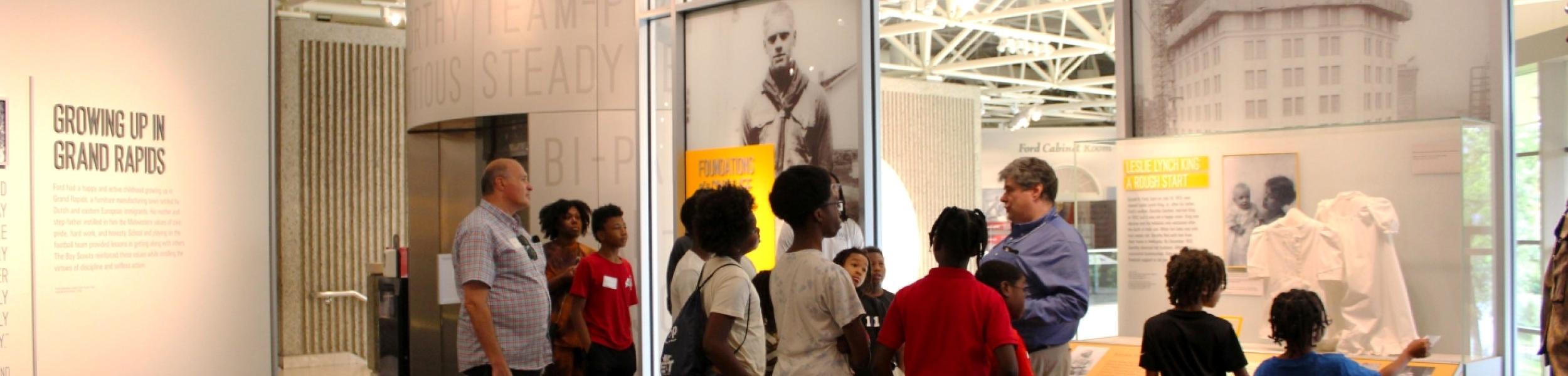group of students tour exhibit
