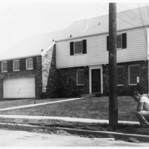 A black and white, exterior picture of the Ford family house is shown
