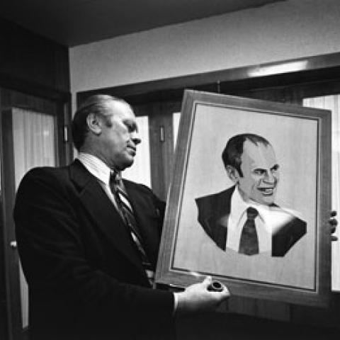 A2090-19. President Ford examines a wood portrait of himself given by Soviet General Secretary Leonid Brezhnev.  Okeansky Sanatorium.  November 23, 1974.