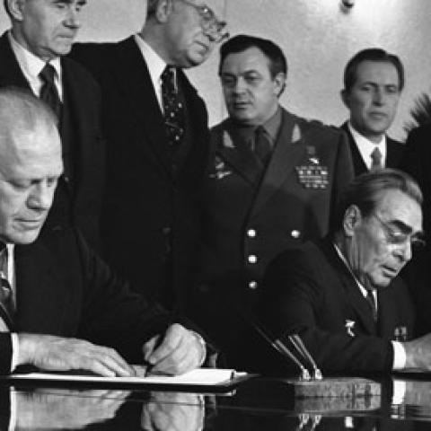 A2092-03A - President Ford and Soviet General Secretary Leonid I. Brezhnev sign a Joint Communiqué following talks on the limitation of strategic offensive arms. The document was signed in the conference hall of the Okeansky Sanitarium, Vladivostok, USSR. November 24, 1974.