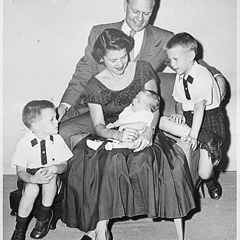 0006-1. Mrs. Ford holds Steven Ford as Gerald R. Ford, Jr., Jack Ford, and Michael Ford look on. June 1956.