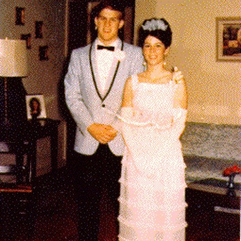 H0072-11. Mike Ford poses with his prom date in the living room of the family residence at 514 Crown View Drive, Alexandria, VA. 1968.