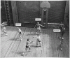 H0060-4. Gerald R. Ford, Jr. guards the net during a basketball game on the forward elevator of the USS MONTEREY. As physical education director it was Mr. Ford's idea to create a basketball court on the elevator. 1944.