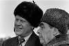 A2102-07A - President Ford dons a Russian wool cap upon his arrival in Soviet Union, shown here with Soviet General Secretary Leonid Brezhnev at Vozdvizhenka Airport, Vladivostok, USSR.  November 23, 1974.
