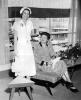 AV82-18-0216. Betty and her mother-in-law Dorothy Ford pose for a photo while attending a luncheon at Herpolsheimer's department store, where Betty had previously worked as a fashion coordinator. Grand Rapids, Michigan. July 20, 1949. 