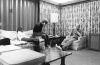 A0448-17. President Ford relaxes with son Steve and Steve's guest Dee Dee Jarvis in the Aspen Lodge at Camp David. September 1, 1974.