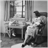 H0010-1. Betty Ford holds infant Jack Ford in her arms while Michael Ford plays at a small table in their apartment at 1521 Mount Eagle Place, Alexandria, VA. 1952.