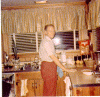 H0072-9. Gerald R. Ford tackles the clean up chores in the kitchen of the family residence at 514 Crown View Drive, Alexandria, VA. 1972.