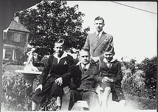 H0019-4. Gerald R. Ford, Jr. is flanked by half-brothers Richard A. Ford, and  James F. Ford, while Thomas G. Ford stands behind him for a family portrait. 1938.