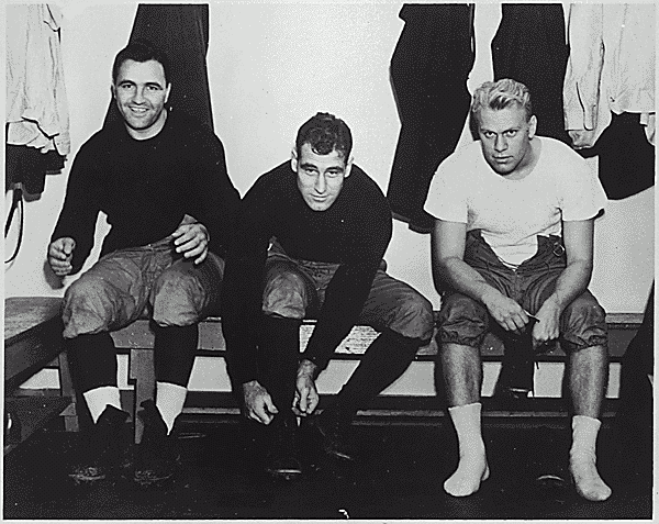 H0035-4.  Gerald R. Ford, Jr. and fellow football coaches James DeAngelis and Ivan      Williamson get ready for practice at Yale University, New Haven, CT. Fall 1938.
