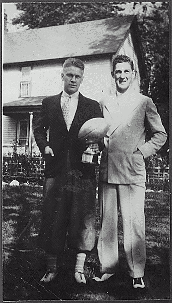 H0037-2. Gerald R. Ford, Jr. holds the trophy he received at the best freshman in spring practice while standing with University of Michigan football teammate Herman Everhardus. 1932.