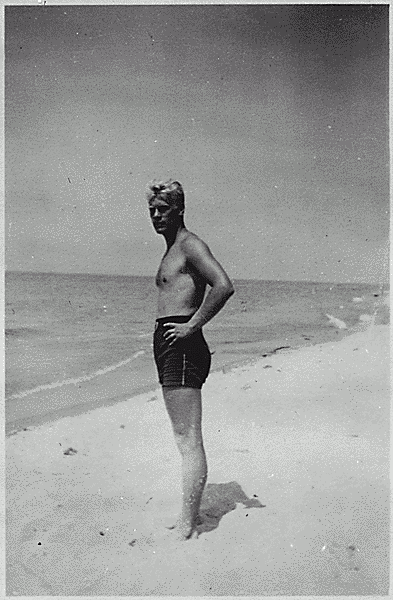 H0037-3. Gerald R. Ford, Jr. stands on the shore at Ottawa Beach, MI, site of his parent's summer cottage. 1940.