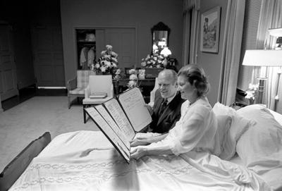 A1170-18A President and Mrs. Ford read a petition, signed by all 100 members of the United States Senate, in the President's Suite at Bethesda Naval Hospital, Bethesda, MD, following the First Lady's breast cancer surgery. October 2, 1974.