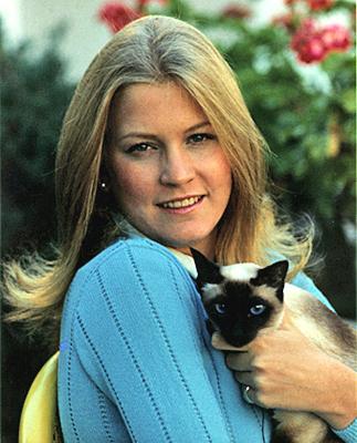 A1206-12A. Susan Ford with Shan, the Ford family's Siamese cat. October 4, 1974.