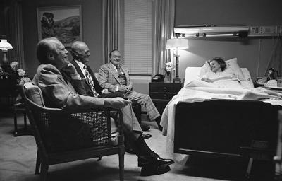 A1223-20A - President Ford, Bob Hope, and Hugh Davis visit Mrs. Ford at the Bethesda Naval Hospital, Bethesda, MD, during her recovery from breast cancer surgery. October 5, 1974.