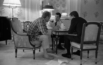 A2046-09A - President Ford, in his pajamas, meets with staff members Steve Todd (military aide) and Terry O'Donnell in the President's suite in the Akasaka Palace, Tokyo, Japan. November 19, 1974.