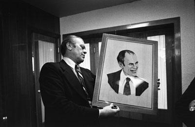 A2090-19. President Ford examines a wood portrait of himself given by Soviet General Secretary Leonid Brezhnev.  Okeansky Sanatorium.  November 23, 1974.