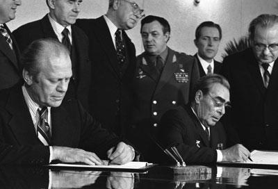 A2092-03A - President Ford and Soviet General Secretary Leonid I. Brezhnev sign a Joint Communiqué following talks on the limitation of strategic offensive arms. The document was signed in the conference hall of the Okeansky Sanitarium, Vladivostok, USSR. November 24, 1974.