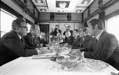 A2107-29A. President Ford, Secretary of State Henry Kissinger and other U.S. representatives meet with General Secretary Brezhnev, Foreign Secretary Gromyko, Ambassador Dobrynin, and others aboard a Russian train headed for Vladivostok, USSR.   November 23, 1974. 