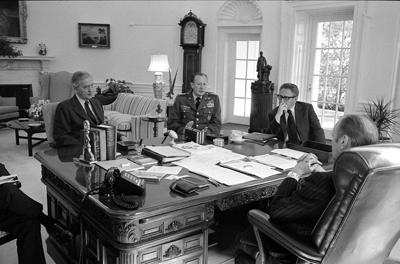 A3779-08 - President Ford meets with Secretary of State Henry Kissinger, Army Chief of Staff General Frederick Weyand, and Graham Martin, Ambassador to Vietnam, in the Oval Office. March 25, 1975.