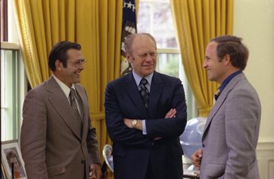 A4256-04 - President Ford chats with Chief of Staff Donald Rumsfeld and Rumsfeld’s assistant Richard Cheney in the Oval Office. April 28, 1975.