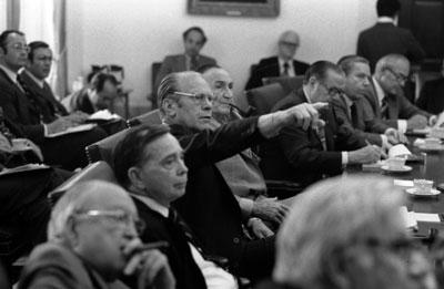 A4537-12A. President Ford points to a map of the Cambodian coastal area during a presentation by Secretary of State Henry Kissinger at a briefing on the Mayaguez situation for the Bipartisan Congressional Leadership. May 14, 1975.