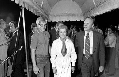 A6311-33. Surrounded by Secret Service agents and the press on the South Portico of the White House, President and Mrs. Ford, with their son Steve, return home following the attempt on the President's life by Lynette "Squeaky" Fromme. September 5, 1975