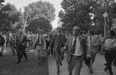 A6320-23A. Secret Service agents rush President Ford towards the California State Capitol following the attempt on the President's life by Lynette "Squeaky" Fromme, in Sacramento, California.  September 5, 1975 