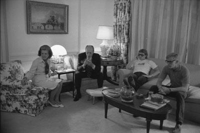 A6332-04. President Ford and First Lady Betty Ford and their sons Jack and Steve watch television news coverage of the attempt on the President's life by Lynette "Squeaky" Fromme in the White House residence. September 5, 1975