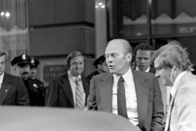 A6521-22A - President Ford winces at the sound of the gun fired by Sara Jane Moore during the assassination attempt in San Francisco, California.  September 22, 1975
