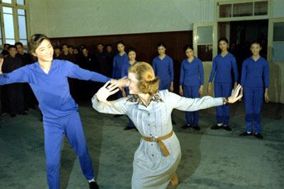 A7545-20A. While touring the Central May 7th College of Art in Peking, People's Republic of China, First Lady Betty Ford shares a dance move with one of the students. December 3, 1975