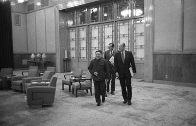 A7620-15A. After bilateral talks Vice Premier Teng Hsiao-P’ing leads President Ford and Chief U.S. Liaison Officer George H.W. Bush through the Great Hall of the People.  Beijing, China. December 2, 1975.