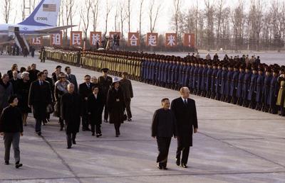 A7630-04A - Escorted by Deng Xiao Ping President Ford inspects the honor guard upon his arrival in China with his entourage, which included Mrs. Ford and Secretary of State Henry Kissinger. Beijing, China. December 1, 1975.