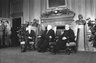 A7732-16 - President Ford with Supreme Court Chief Justice Warren Burger and Associate Supreme Court Justice John Paul Stevens. December 19, 1975.