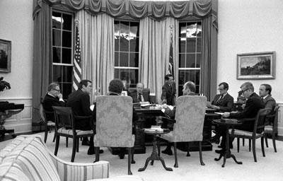 A8860-19A. President Ford conducts a nighttime meeting with his advisers to discuss a note received from Soviet General Secretary Leonid Brezhnev about Strategic Arms Limitation Talks (SALT). March 18, 1976.