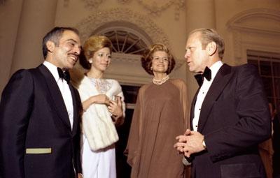 A9002-15A. President and Mrs. Ford say goodnight to King Hussein and Princess Alia of Jordon as they depart the White House after a state dinner in their honor.  March 30, 1976.