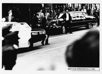 AV89-26-15. Reaction of Secret Service agents, police, and bystanders approximately three seconds after Sara Jane Moore attempted to assassinate President Gerald R. Ford in San Francisco, California.  September 22, 1975.