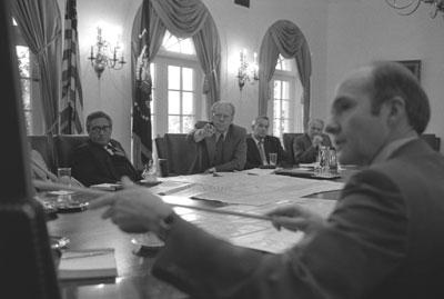 B0253-03A. President Ford and National Security Adviser Brent Scowcroft point to a map of Beirut during discussions on the evacuation of Americans. June 17, 1976