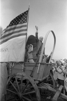 B0510-35. President Ford boards the Michigan wagon at the Bicentennial Wagon Train Pilgrimage encampment, where covered wagon trains converged after crossing the nation on historical trails.  Valley Forge State Park, Valley Forge, Pennsylvania.  July 4, 1976. 