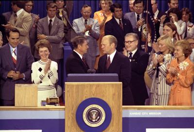 B1272-18A - President Ford, as the Republican nominee, shakes hands with nomination foe Ronald Reagan on the closing night of the Republican National Convention. August 19, 1976.