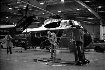 B2791-28. President Ford keeps in golf shape during a practice session in the Marine One Hangar at Andrews Air Force Base.  January 13, 1977. 