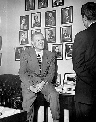 H0011-03. Representative Gerald R. Ford, Jr., talks to an unidentified visitor in his House Office. 1950