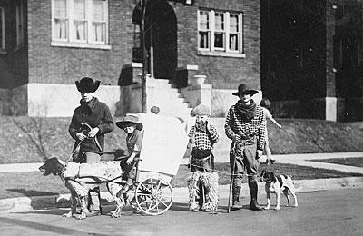 H0023-04. Gerald R. Ford, Jr., Carl Engel, Tom Ford, and an unidentified boy pose with their pioneer wagon after winning first prize in the Boys Day Parade. 1923.