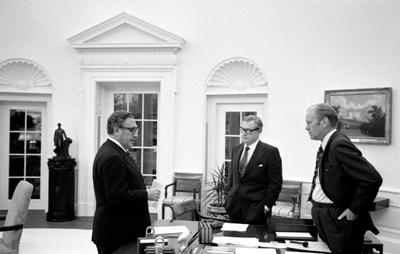 A4241-30A. President Ford meets in the Oval Office with Secretary of State Henry Kissinger and Vice President Rockefeller to discuss the American evacuation of Saigon. April 28, 1975.