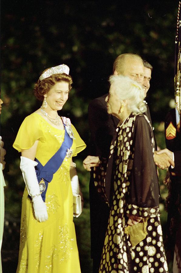 B0565-09A. Queen Elizabeth II greeting Alice Roosevelt Longworth, daughter of President Theodore Roosevelt, in the receiving line on the South Driveway of the White House prior to a state dinner honoring Her Majesty. July 7, 1976.