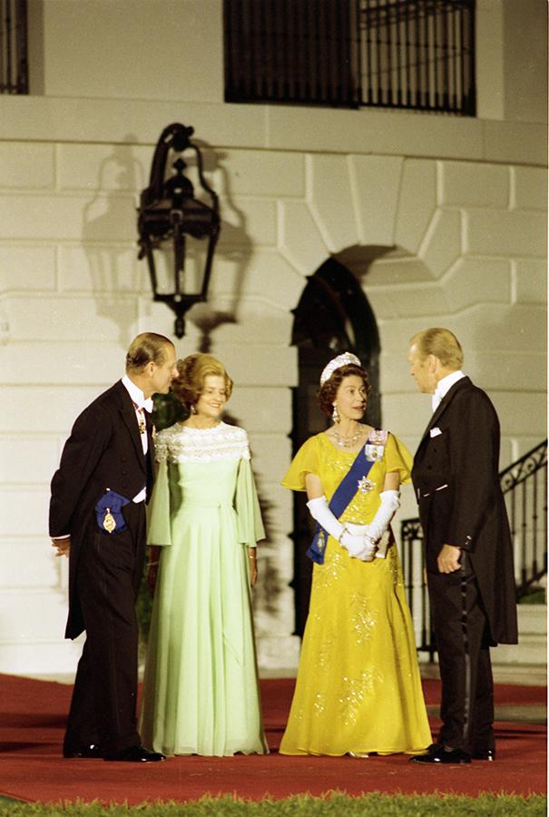 B0569-34. President and Mrs. Ford Standing With Queen Elizabeth II and Prince Philip on the South Portico of the White House prior to a state dinner honoring Her Majesty. July 7, 1976. 