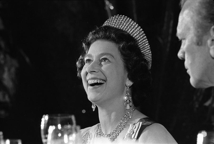 B0594-05A. Queen Elizabeth II laughs during a state dinner held in her honor.  July 7, 1976.