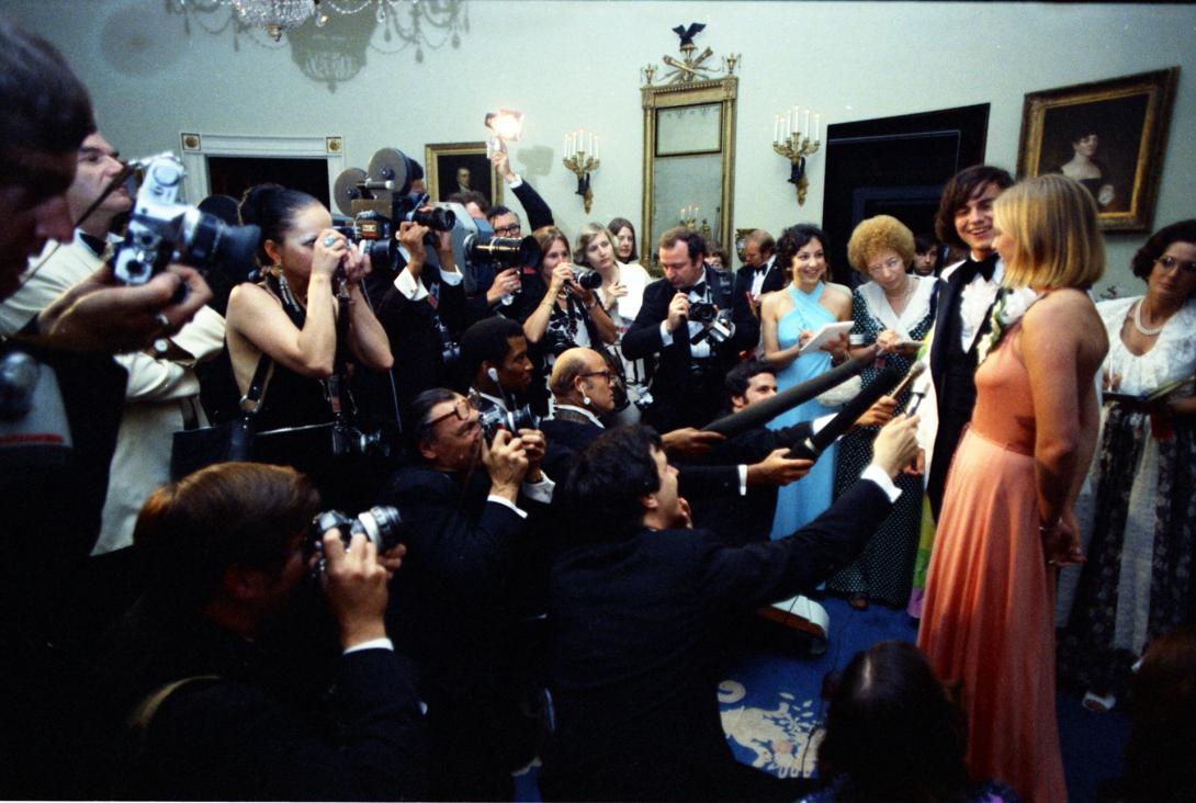 38-WHPO-A4765-11. Susan Ford and her date Billy Pifer speaking with reporters at the Holton-Arms School Senior Prom, 5/31/1975.