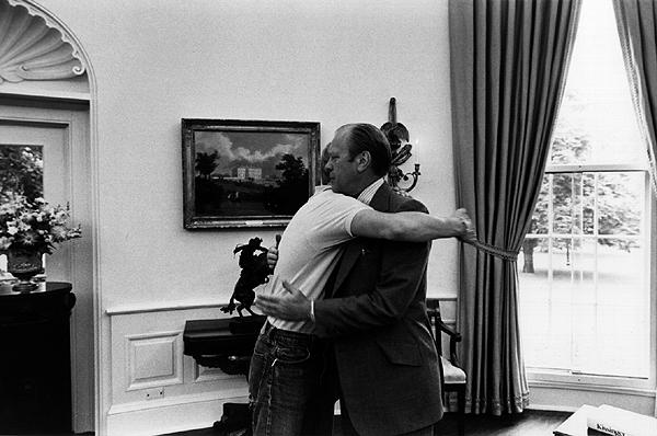 A0494-17A. President Ford and son Steve in the Oval Office as Steve prepares to leave on a cross-country jeep trip. September 3, 1974.